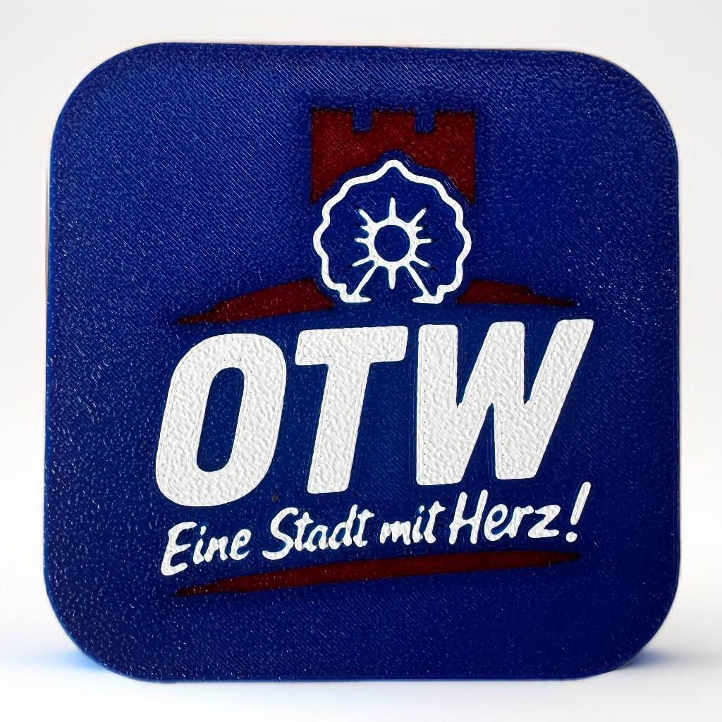 Blauer OTW Kühlschrankmagnet mit dem Schriftzug „Eine Stadt mit Herz!“