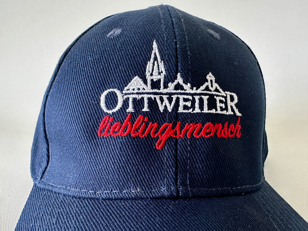 Nahaufnahme der Stickerei: weiße Ottweiler-Silhouette mit Schriftzug „Ottweiler“ und darunter rot gestickt „lieblingsmensch“